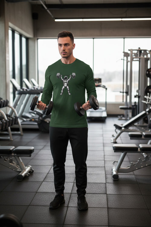 Green long-sleeve shirt with an astronaut lifting weights graphic on a white background